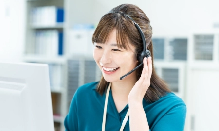 笑顔で通話する女性コーディネーターの画像